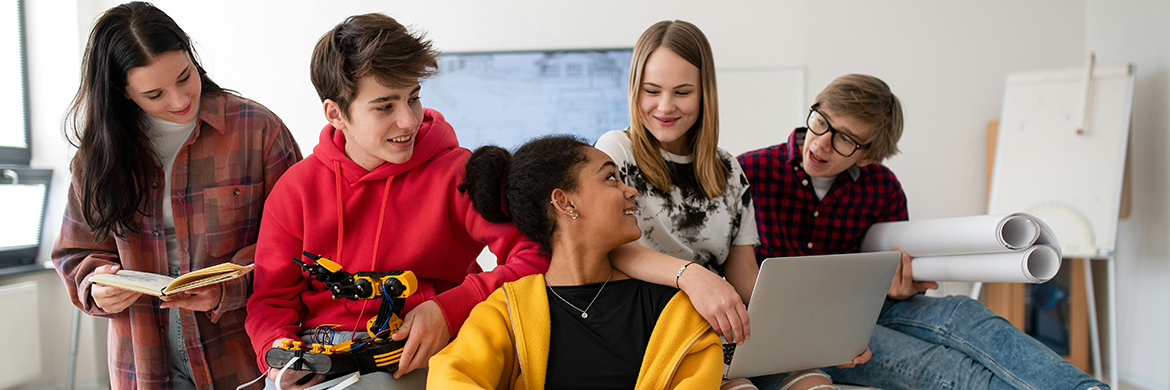 Group of four teens, three girls and two boys, sitting together and having a discussion