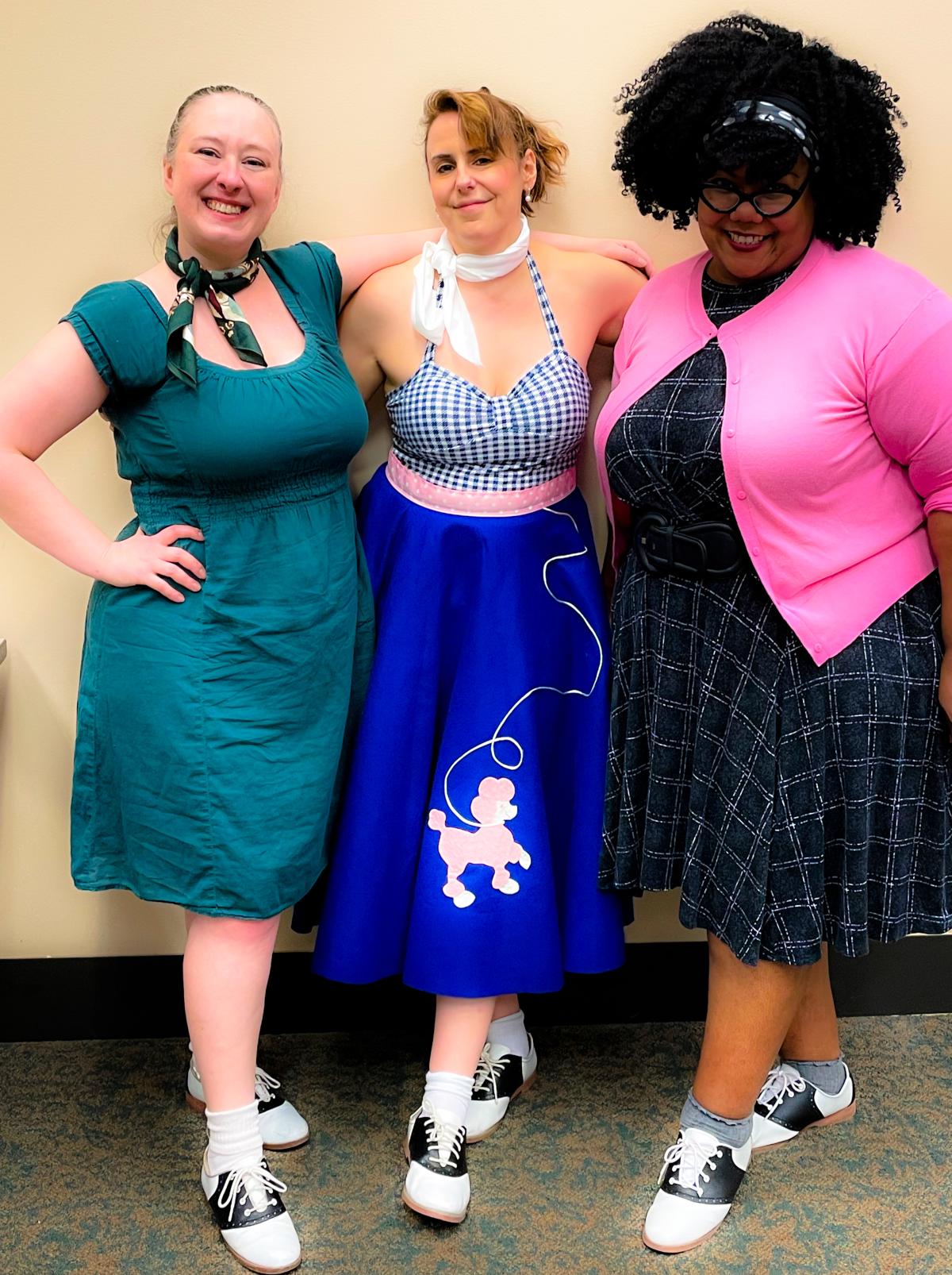 Three women posing in 1950s clothing