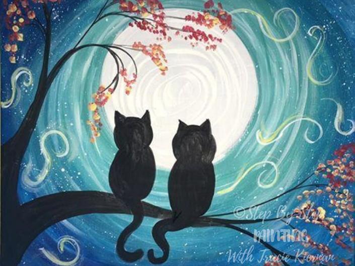 Silhouette of two cats sitting on a tree branch during a full moon.