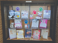 Several books arranged in the library's lobby display case