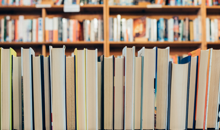 Row of books on shelf in library