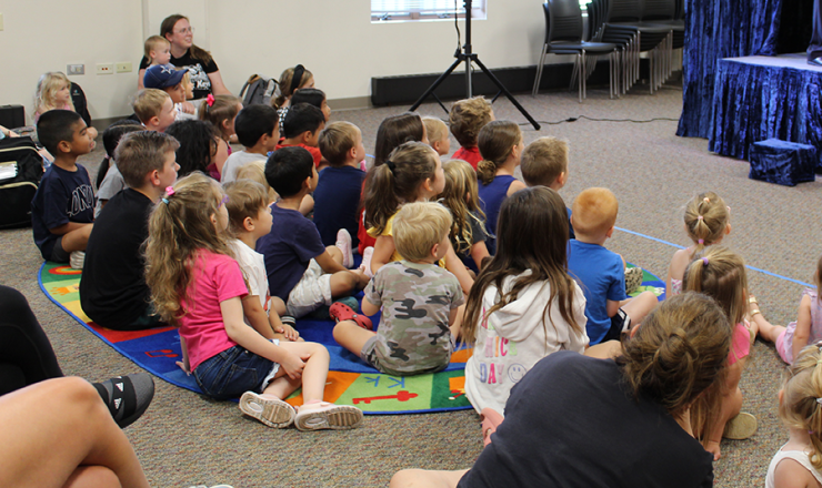 Group of children sitting on the ground during a storytime